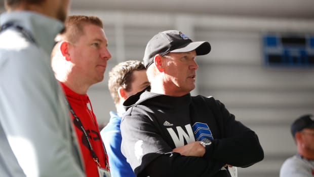 Kansas head coach Lance Leipold talks with assistants and recruiters at Tuesday's practice inside the Kansas Indoor Practice Facility.